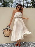 Front resort view of apricot strapless ruffle dress with self-tie waist and flared skirt