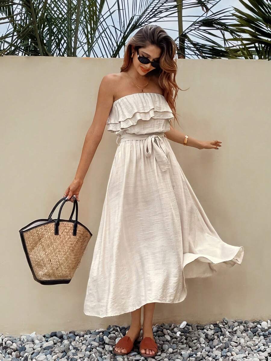 Front resort view of apricot strapless ruffle dress with self-tie waist and flared skirt