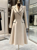 Front View of ivory blazer-style midi dress with black piping for formal work styling