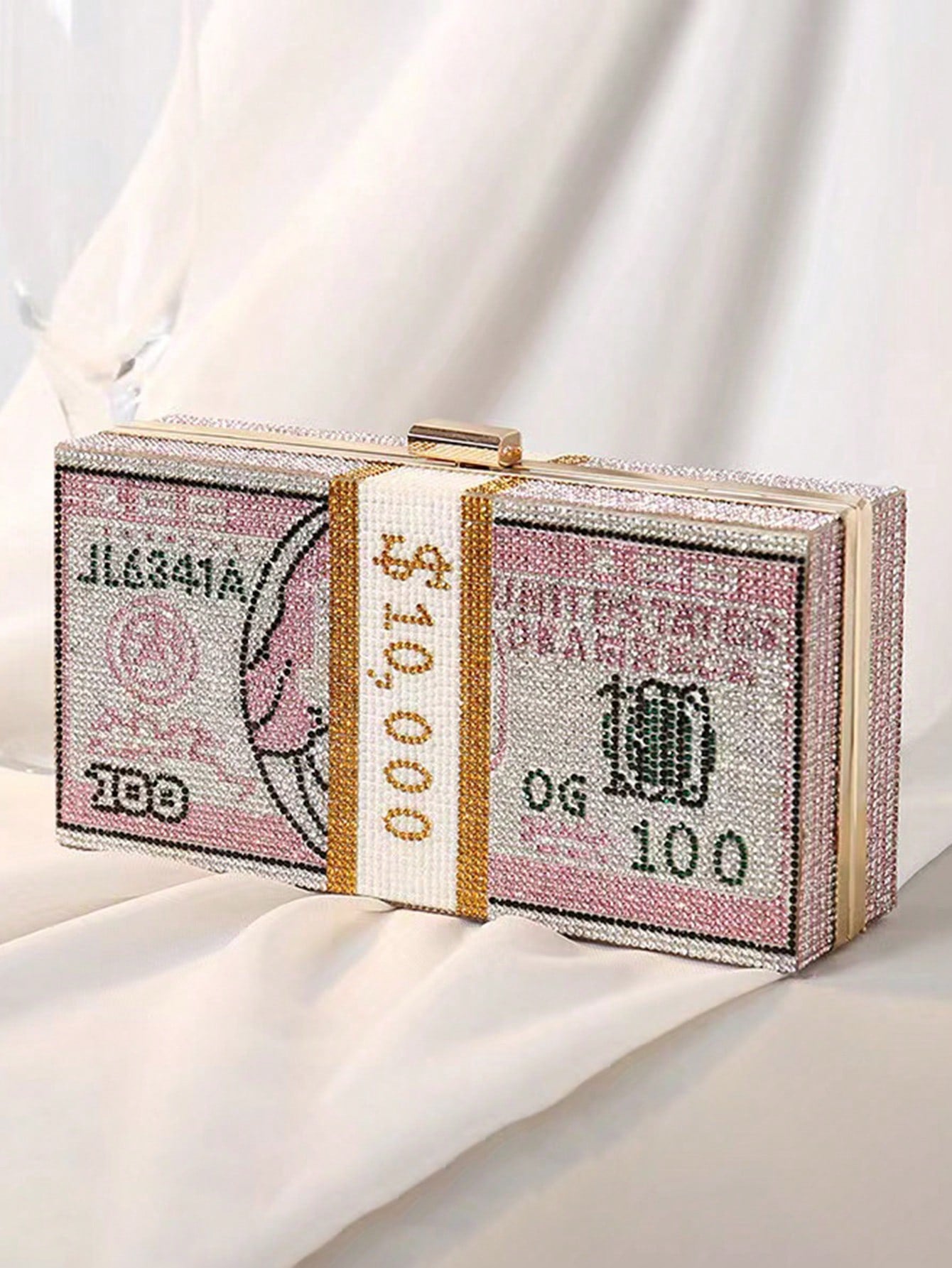 Introducing our Sparkle and Shine Rhinestone Dollar Evening Bag. Add glamour to any party with this dazzling crossbody clutch. Adorned with rhinestone dollar symbols, it's the perfect accessory for a night out. Make a statement and stand out while carrying all of your essentials in style.