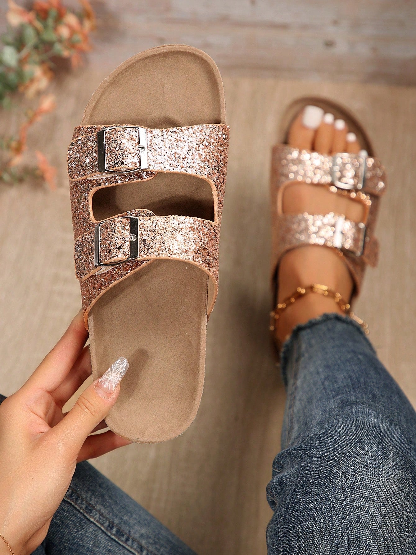 Elevate your style with our Sparkle in Style Glitter Double Buckle Footbed Sandals for Women. These sandals feature a glitter design and double buckle for a chic and trendy look. Enjoy comfort with our footbed design. Perfect for any occasion.
