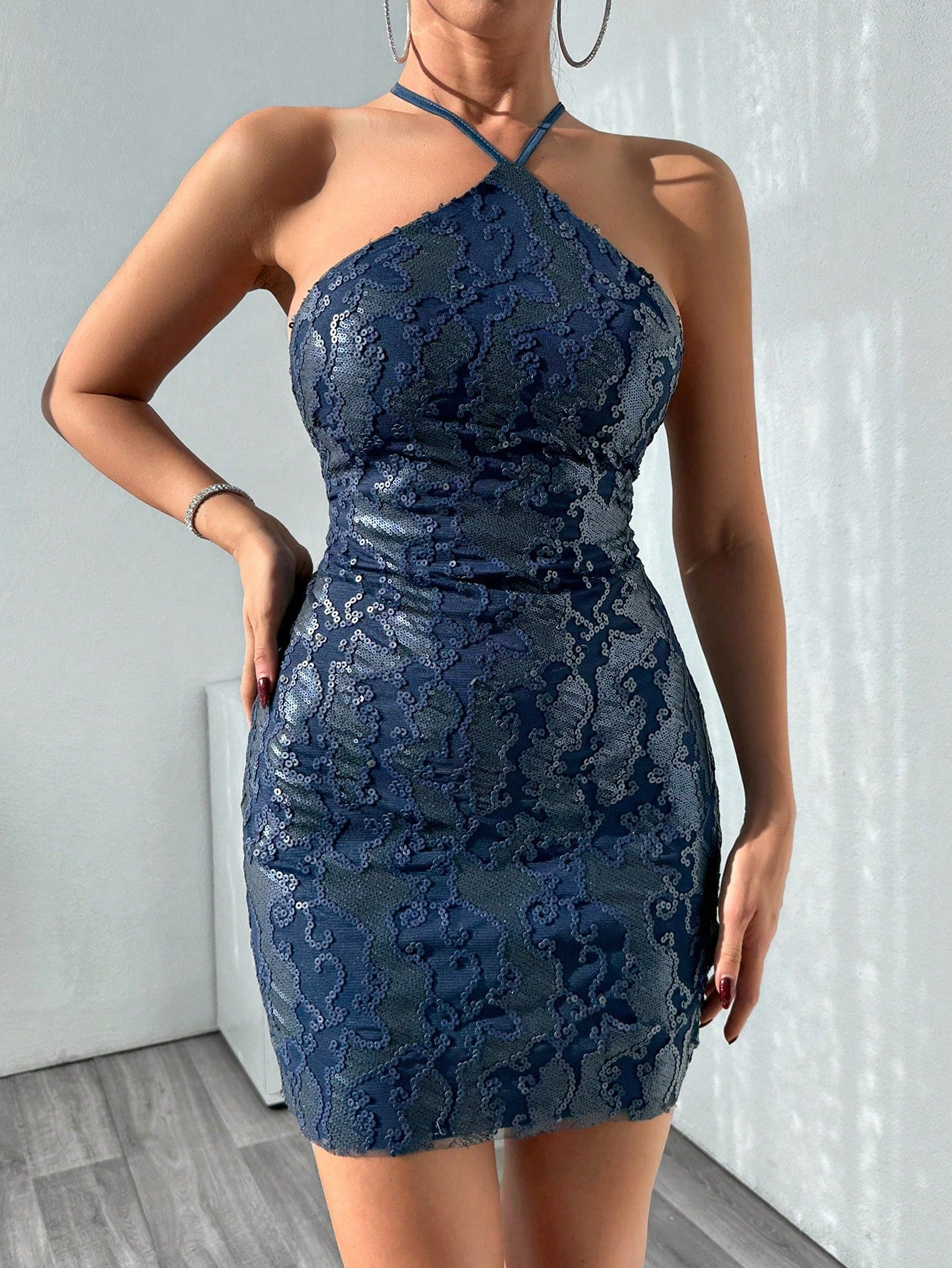 Turn heads at any celebration with this sparkling backless halter party dress. Featuring playful cross straps and a shimmering finish, it’s designed to keep you dancing all night while looking effortlessly chic. Ideal for wedding guests who want to shine with confidence and style.