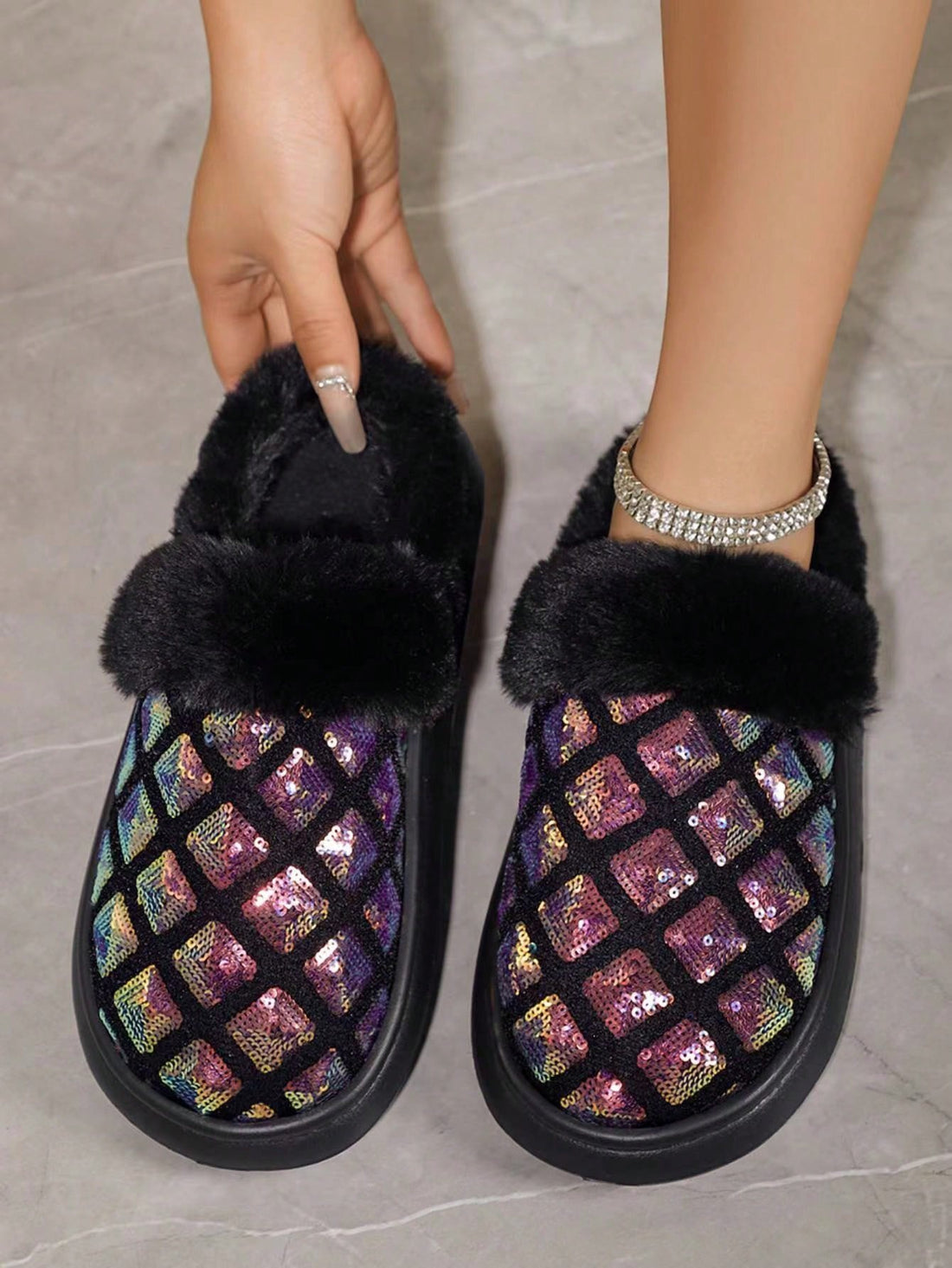 These Sparkling Comfort slip-on house slippers will keep your feet warm and cozy with their warm lining. The glitter-embellished design adds a touch of glamour to your loungewear. Experience comfort and style in these fashionable slippers.