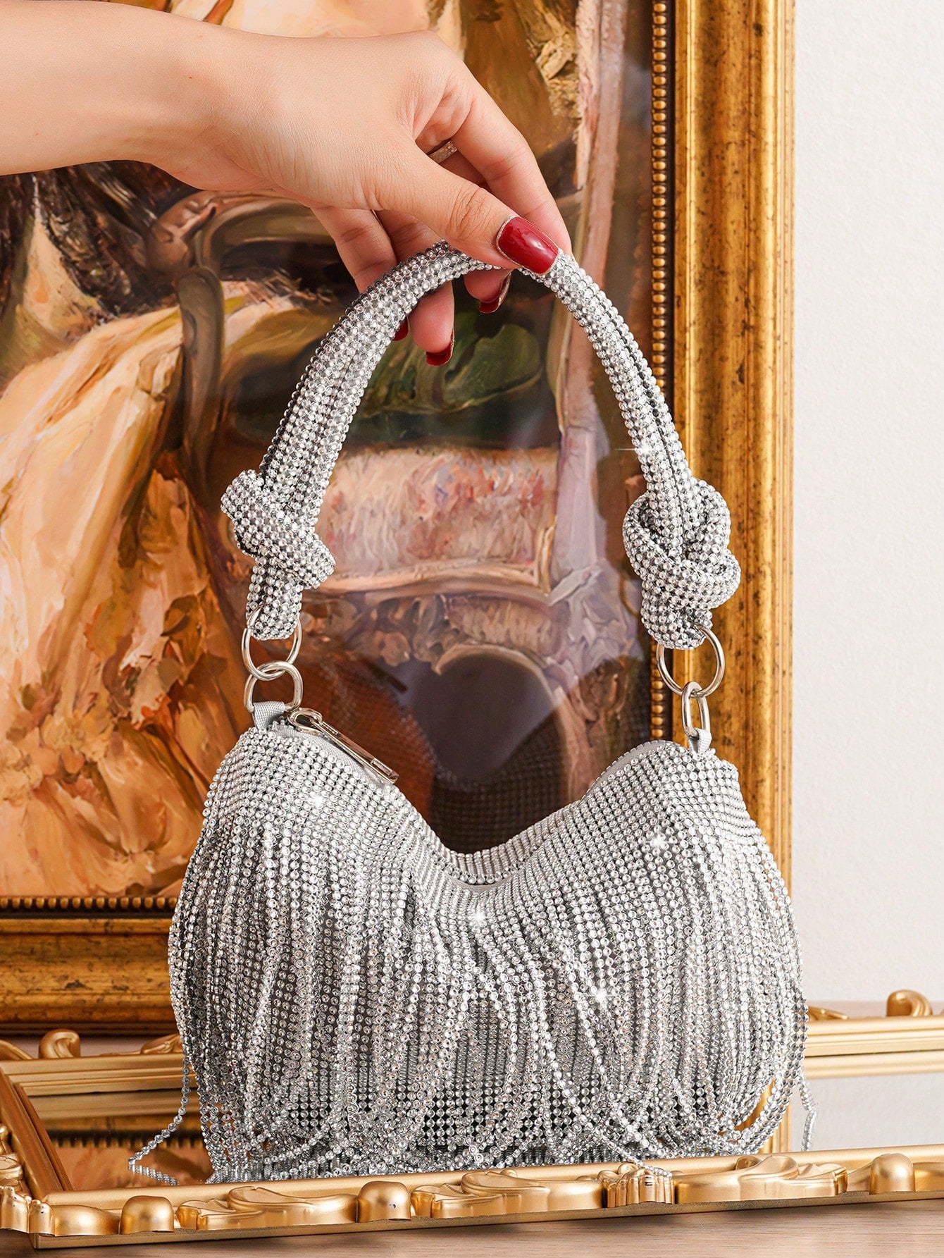Elevate your evening look with our Sparkling Elegance: Fringed Clutch Bag. The shimmering design and fringed details exude glamour, making you stand out in any occasion. Perfect for storing your essentials, this bag adds a touch of elegance to your outfit. Make a statement with this must-have accessory!