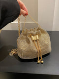 Get ready to dazzle with the Sparkling Elegance mini bucket bag. This glamorous bag features a drawstring closure and is adorned with shimmering rhinestones, making it the perfect accessory for any bridal or evening look. Elevate your style with this stunning and elegant piece.