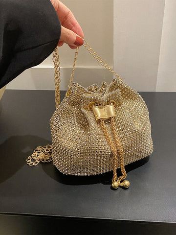 Get ready to dazzle with the Sparkling Elegance mini bucket bag. This glamorous bag features a drawstring closure and is adorned with shimmering rhinestones, making it the perfect accessory for any bridal or evening look. Elevate your style with this stunning and elegant piece.