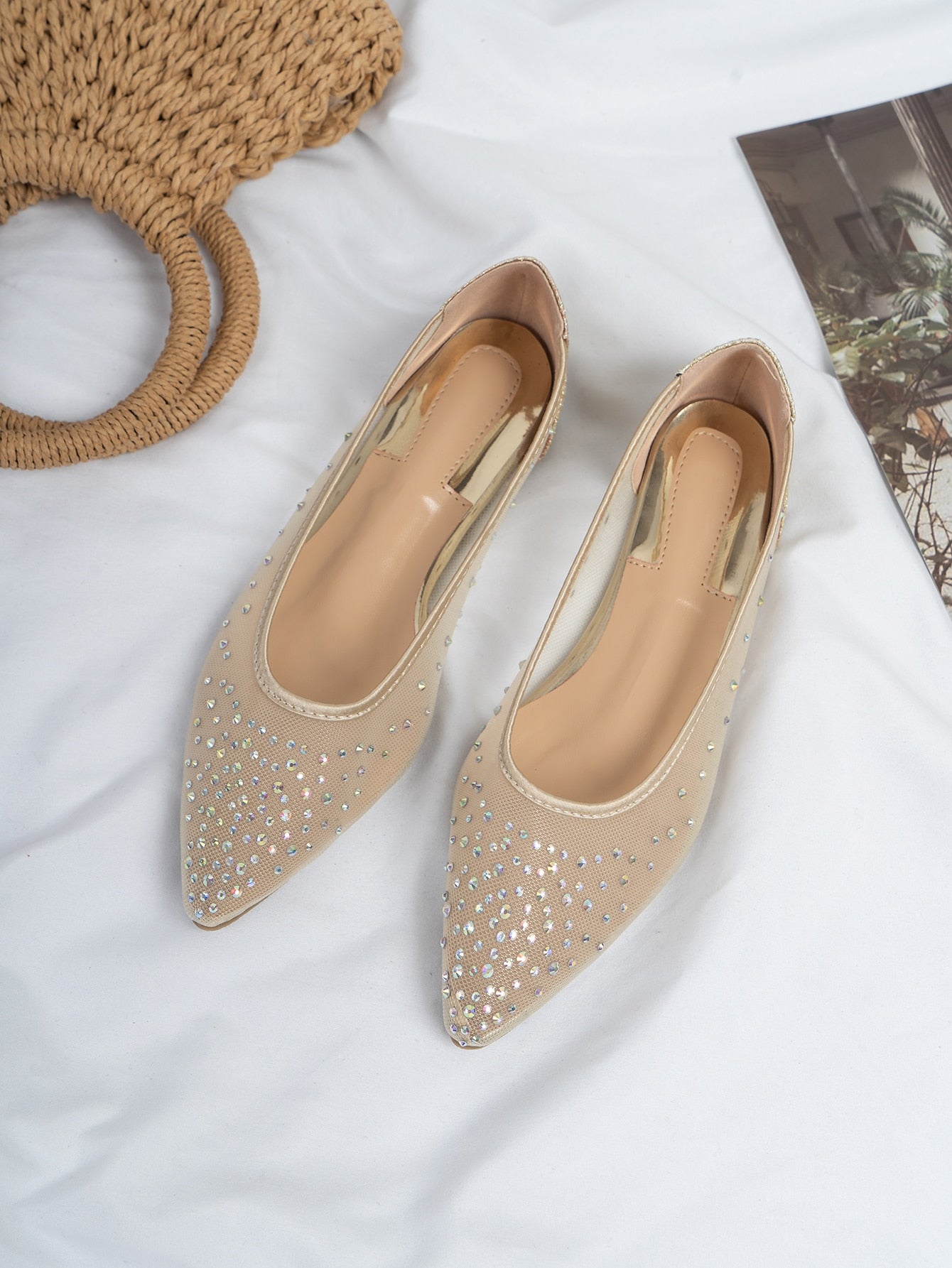 Step up your style game with these dazzling ballet flats. The pointed toe and sparkling rhinestones add a touch of chic to any outfit. Perfect for any occasion, from work to a night out. Shine bright and step confidently with these flats.