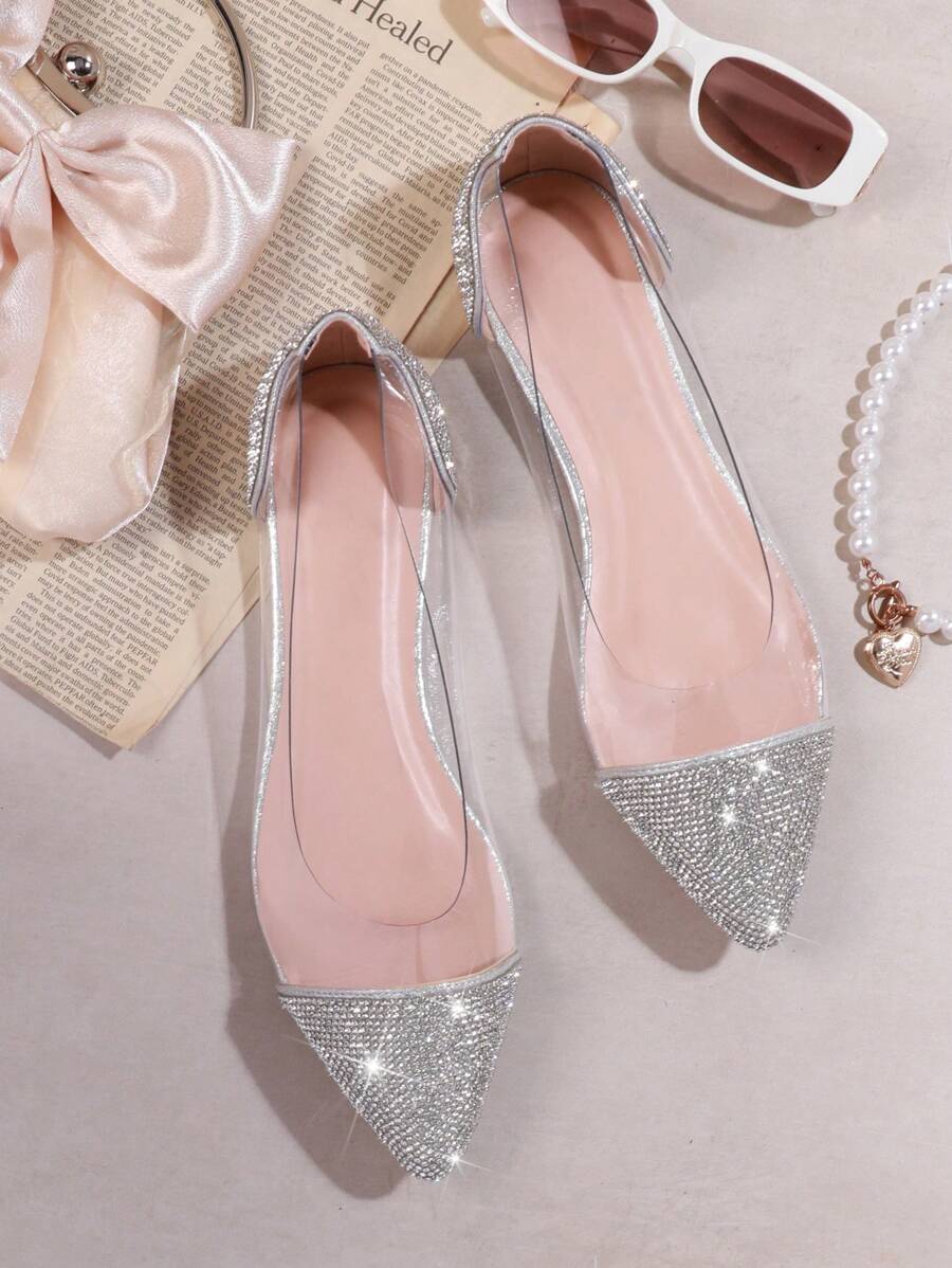 Step into elegance with these stunning rhinestone-embellished pointed toe flats. Crafted from transparent PVC, they offer a modern, sophisticated look perfect for summer occasions. The sparkling rhinestone detailing catches the light beautifully, adding glamour to any outfit. Comfortable and versatile, these flats transition seamlessly from casual daytime wear to evening events. The clear upper showcases your style while remaining breathable for warm weather. 