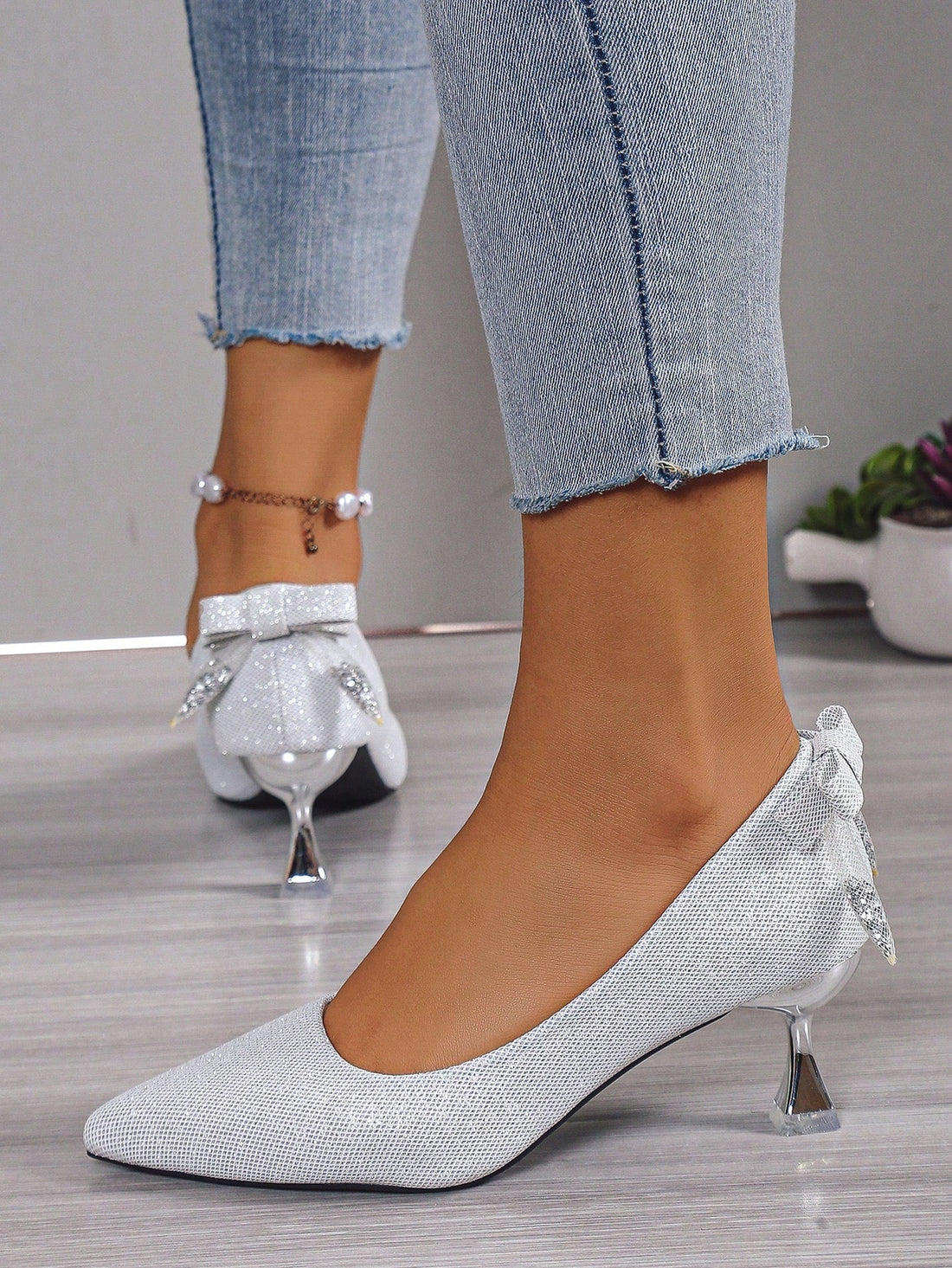 Elevate your bridal ensemble with our Sparkling Stiletto Heels. Designed specifically for weddings, these pointed toe shoes offer a sleek silver finish that sparkles under the lights. With a stiletto heel, these shoes provide both style and stability, making them the perfect choice for any bride.