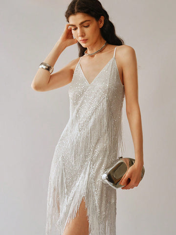 Add some sparkle to your wardrobe with this playful and fun Sparkling Women's V-Neck Sequin Tassel Cami Dress. The asymmetrical hem adds an unexpected twist to the classic cami style and the tassel details add a touch of whimsy. Perfect for a night out or special event, this dress will make you shine!