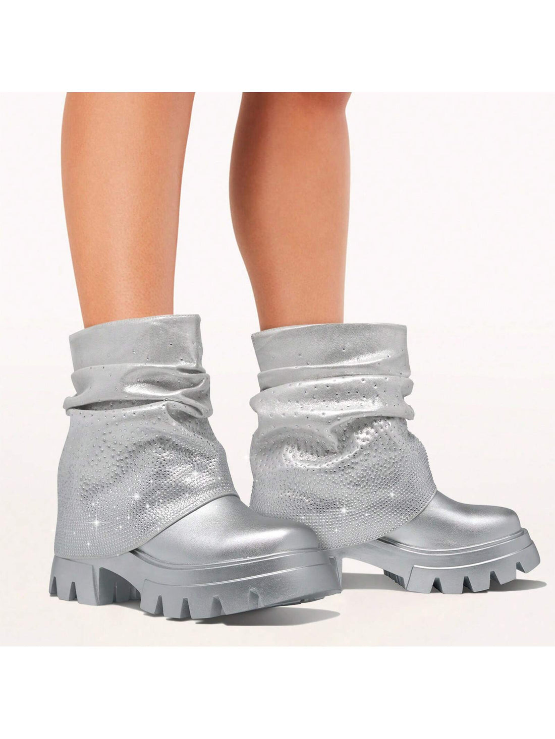 Enhance your style with our Sparkly Silver Rhinestone Ankle Boots. The platform design provides extra height and stability while the rhinestone detailing adds a touch of sparkle to your outfit. These stylish booties are perfect for any occasion, making you stand out from the crowd.
