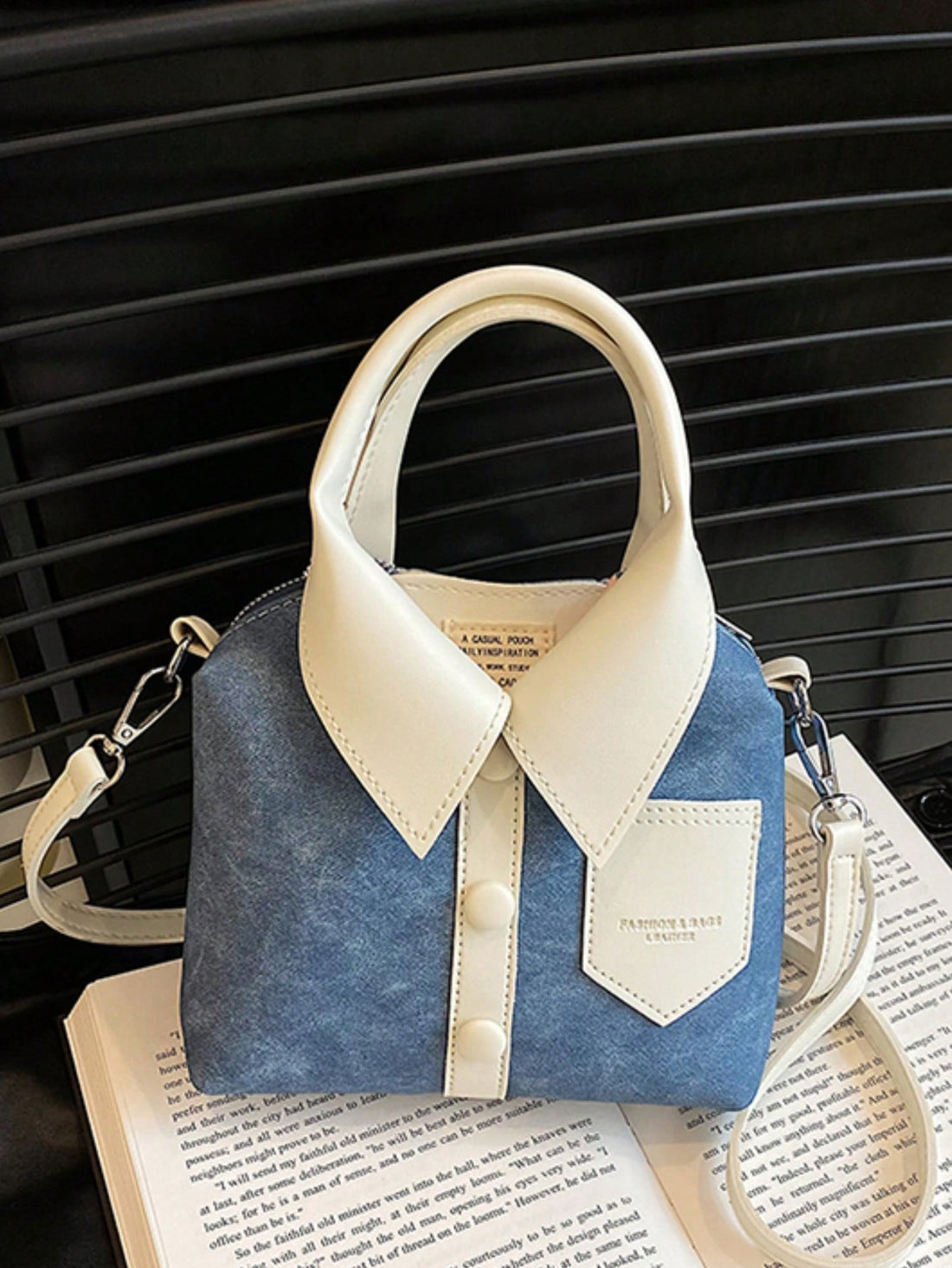 Introducing the Spice Girl Style Satchel, a chic and versatile handheld bag designed for the modern woman. With its simple shirt design and spacious interior, this satchel combines fashion and functionality. Upgrade your style game with this must-have accessory.