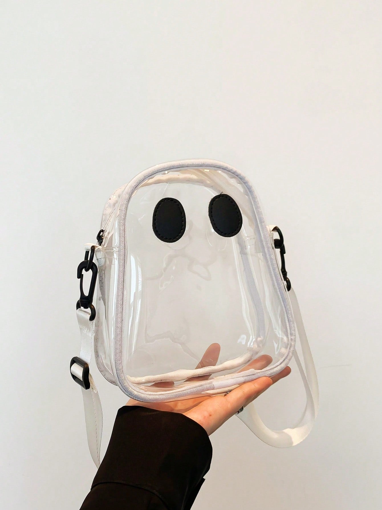 Introducing Spooky Chic's Transparent Ghost Shape Shoulder Bag! Perfect for parties and vacations, this unique bag adds a touch of playfulness to any outfit. Its transparent design and ghost shape make it stand out from the crowd. A must-have accessory for the stylish and adventurous woman.