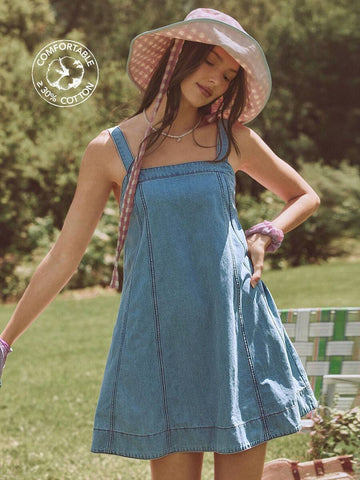 Front three-quarter view of light wash square neck denim mini dress with contrast stitching for summer outings
