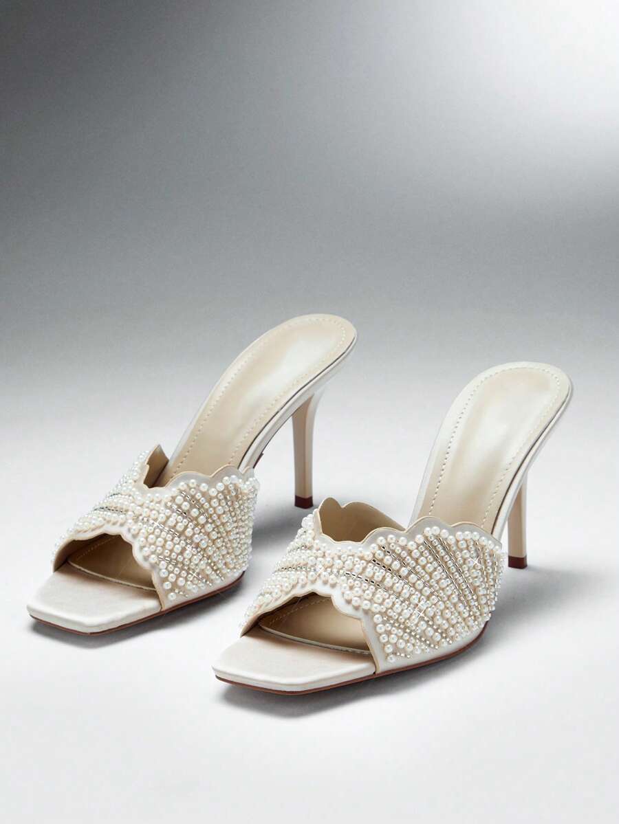Make a sophisticated statement with these glamorous square toe stiletto sandals for women. Designed with a sleek slip on silhouette, elegant square toe, and slender stiletto heel, these sandals create a refined and feminine look that instantly elevates dressy outfits.