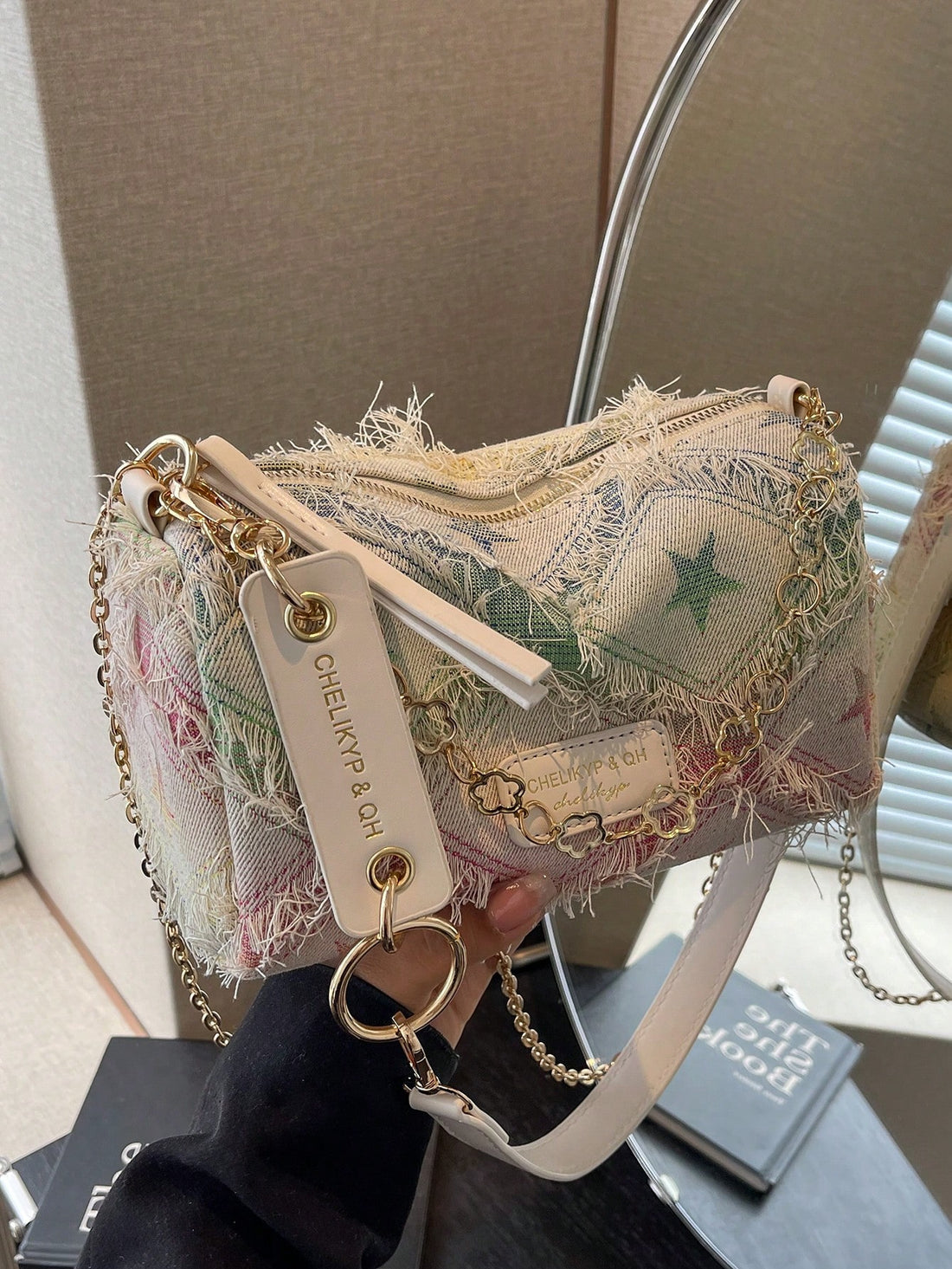 Elevate your style with the Starry Chic shoulder bag. Made with durable canvas and adorned with a colorful chain strap, this bag is perfect for on-the-go fashionistas. Stay on trend while carrying all your essentials.