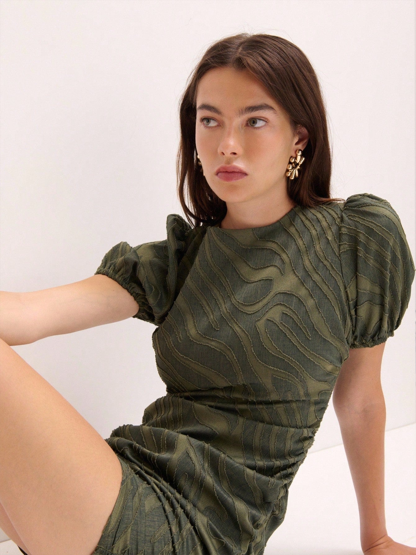 Turn heads at your next event in this eye-catching mini dress that's all about making a bold impression. The textured swirl pattern adds visual intrigue and dimension, while voluminous puff sleeves bring a playful, fashion-forward edge. Perfect for parties, celebrations, and moments when you want to stand out from the crowd. This dress combines statement-making style with comfortable, flattering silhouettes that let you move and celebrate with confidence. Whether you're dancing the night away or mingling at