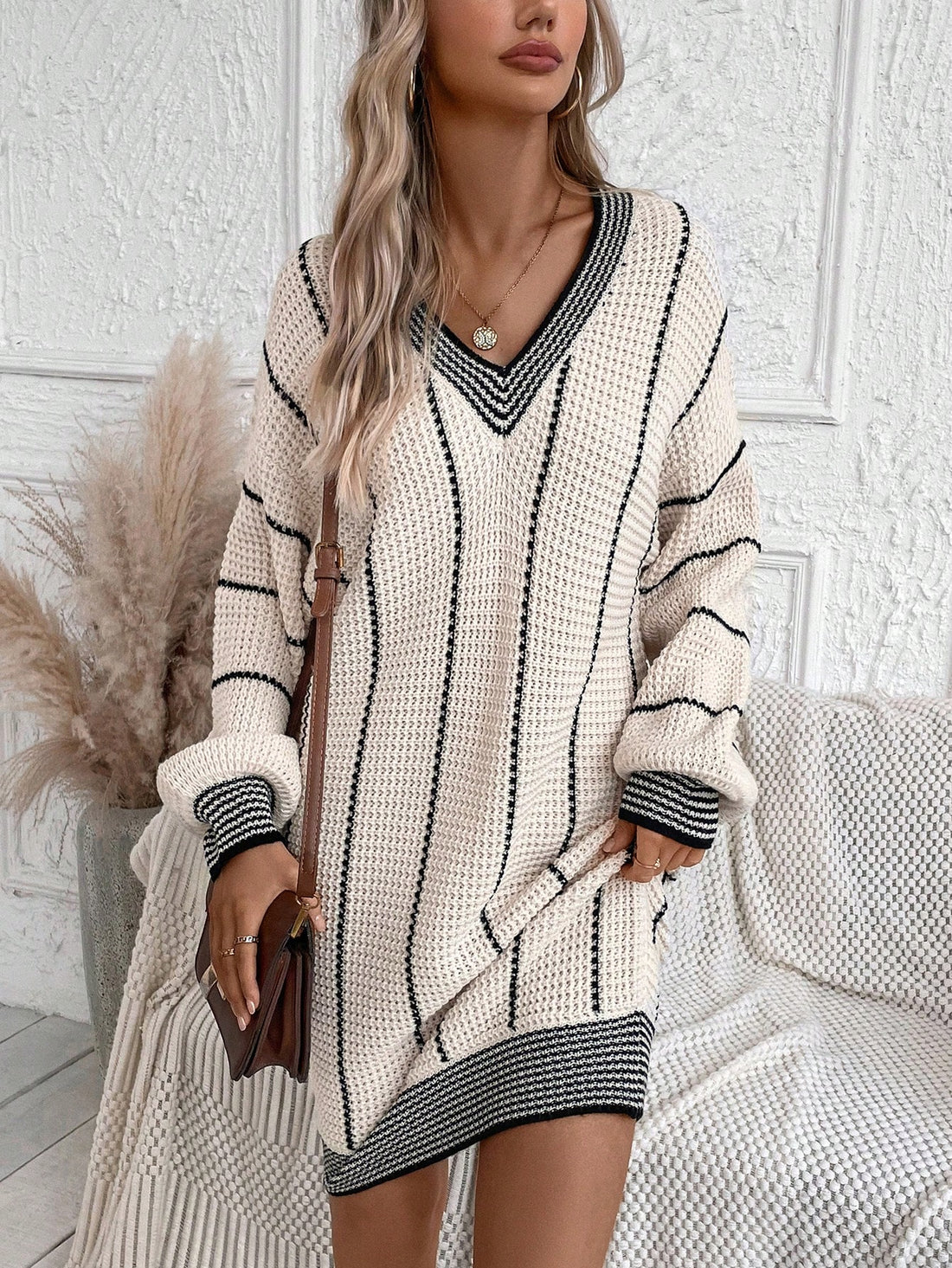 Stay warm and stylish with our Striped Drop Shoulder Sweater Dress. Featuring a unique drop shoulder design and classic stripes, this dress is perfect for any occasion. Made with high-quality materials for ultimate comfort. Elevate your winter wardrobe today!