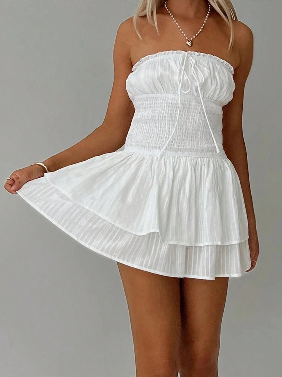 Fresh off the runway, this strapless and backless dress is perfect for the hottest summer nights. The pleated design adds movement and texture, while the mini length keeps it trendy and fun. Perfect for a night out at the club or a chic summer event.