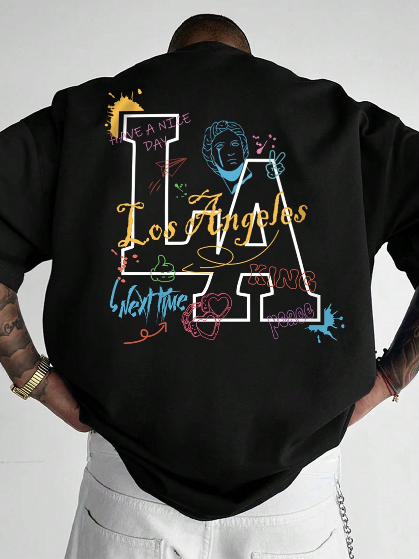 Introducing the Street Style Statement: Men's Graffiti Print Round Neck T-Shirt. Featuring a bold graffiti print, this shirt is perfect for making a statement with your street style. Made with a comfortable round neck design, this shirt is sure to turn heads and make a lasting impression. 