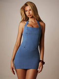Front three-quarter view of medium wash halter denim bodycon mini dress for night-out styling