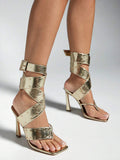 Gold studded spiral-wrap stiletto sandals with square toes and buckle ankle straps