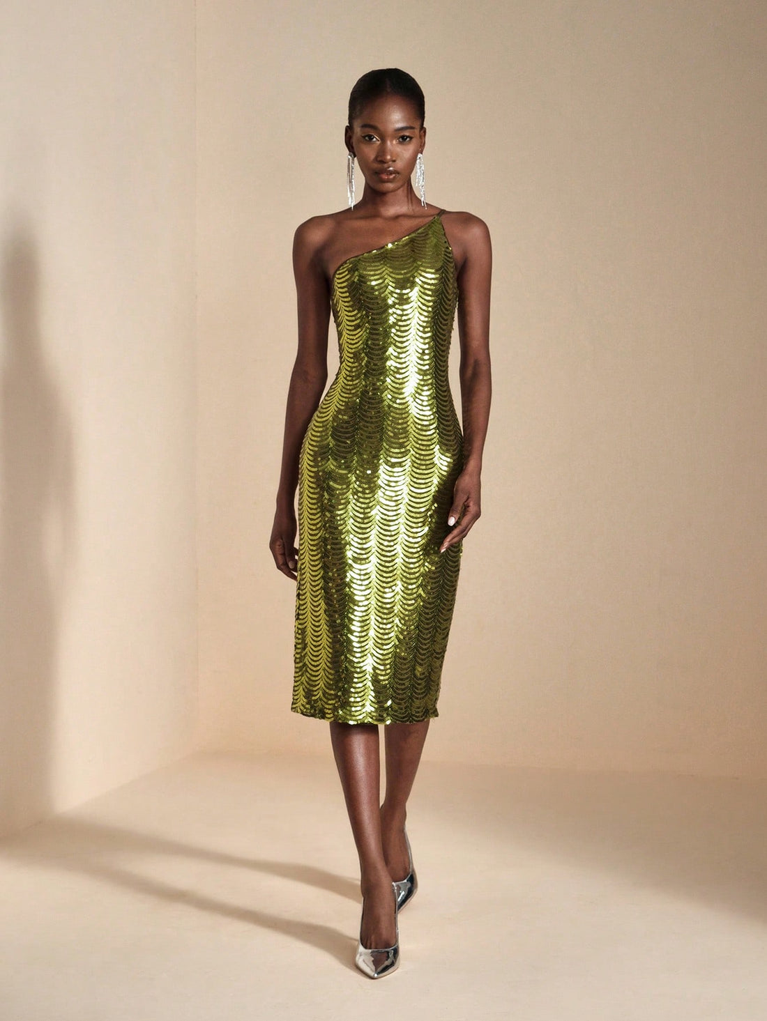 Turn heads at your next event in this show-stopping asymmetric sequin bodycon midi dress! Crafted with shimmering sequins that catch the light from every angle, this dress features a flattering bodycon silhouette and a cheeky side slit for movement and sass. The asymmetric neckline adds modern edge to classic elegance, making it perfect for cocktail parties, date nights, or anywhere you want to feel absolutely fabulous. Slip it on and let your confidence do the talking!