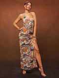 Turn heads with this Stunning Floral & Animal Print Draped Neck Maxi Halter Dress. Its vibrant mix of floral and animal patterns brings wild elegance to any occasion, while the draped neckline adds a touch of playful sophistication. Flowing maxi length ensures comfort and movement, perfect for dancing the night away or strolling through summer soirées. Embrace your fun side with a dress that’s as bold and beautiful as you are!