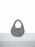Elevate your evening look with this exquisite handmade beaded mini clutch. Crafted with meticulous attention to detail, this silver novelty bag features a textured beaded design that catches the light beautifully. The compact size fits essentials perfectly, while the top handle ensures easy carrying. Its minimalist aesthetic and flap closure make it an ideal accessory for autumn and winter celebrations, from cocktail parties to formal gatherings. A sophisticated statement piece that transforms any outfit.