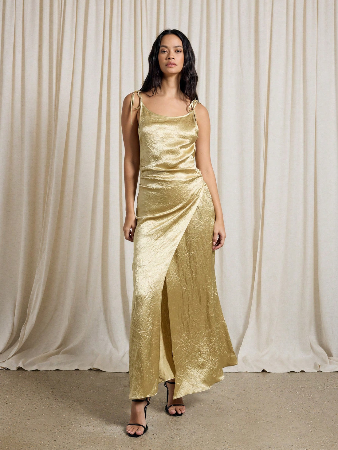 Slip into pure elegance with this show-stopping metallic gold evening gown that's basically a wearable love letter to glamour. The luxe fabric catches the light beautifully, while the tasteful side slit adds just the right amount of sass and movement. Whether you're walking down the aisle as a guest, celebrating a milestone, or turning heads at your next special event, this gown delivers red-carpet vibes without the red-carpet price tag. Dress it up with statement jewelry and heels, and prepare for all the 