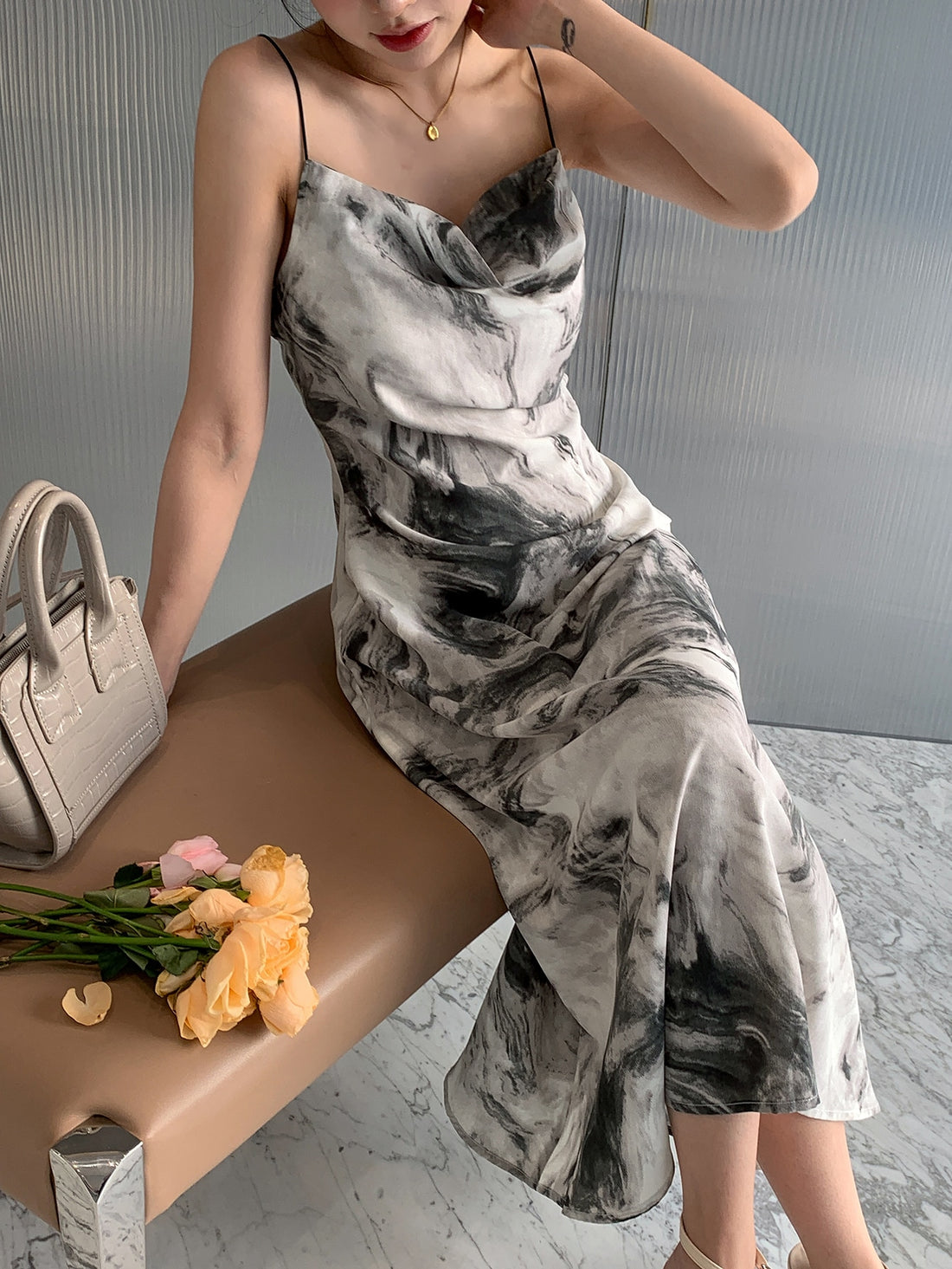 Slip into Effortless Elegance with our Stylish Allover Print Draped Collar Cami Dress! Perfect for every occasion, this dress features a unique allover print and a flattering draped collar. Step out in style and comfort with this must-have wardrobe staple.
