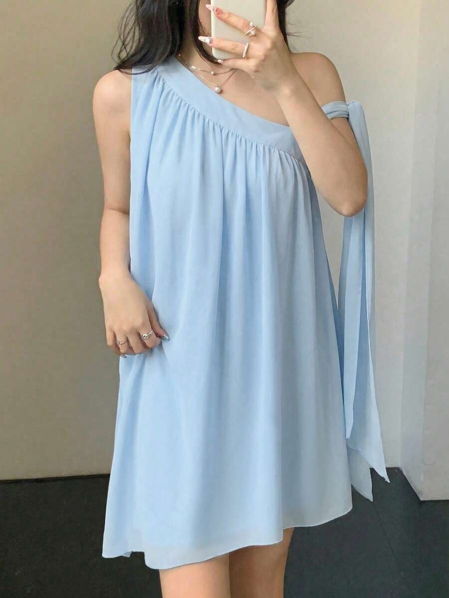 Front view of light blue one-shoulder A-line mini dress showing visible color, print, and silhouette
