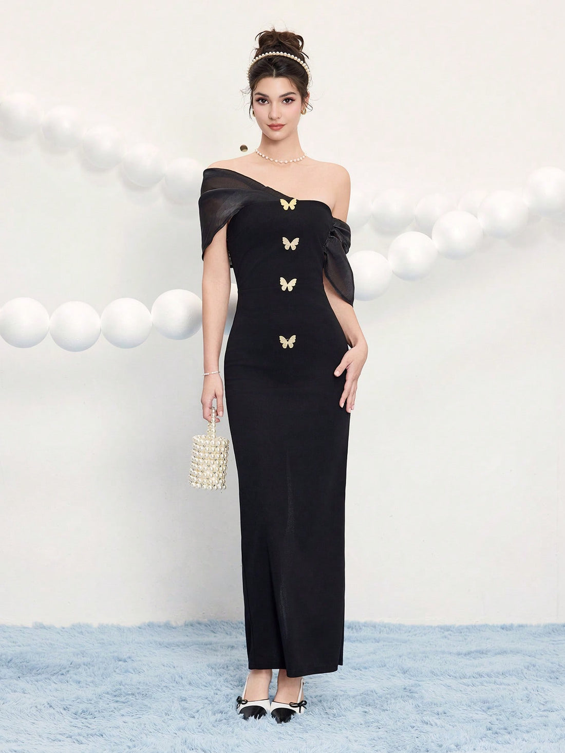 Make a statement at your next event in this stunning black cocktail dress that effortlessly blends elegance with eye-catching details. Adorned with delicate butterfly gold buttons and a sleek metal buckle, this dress transforms any occasion into a fashion moment. Perfect for weddings, festivals, and celebrations where you want to stand out, it combines timeless black sophistication with playful metallic accents that catch the light beautifully. Whether you're dancing the night away or mingling with guests, 