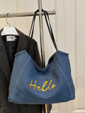 Brighten your summer days with this playful blue nylon tote bag! Lightweight and durable, it features a secure metal snap closure and charming embroidery that adds a fun, stylish touch. Perfect for carrying your essentials on casual outings, this tote combines practicality with a splash of personality.
