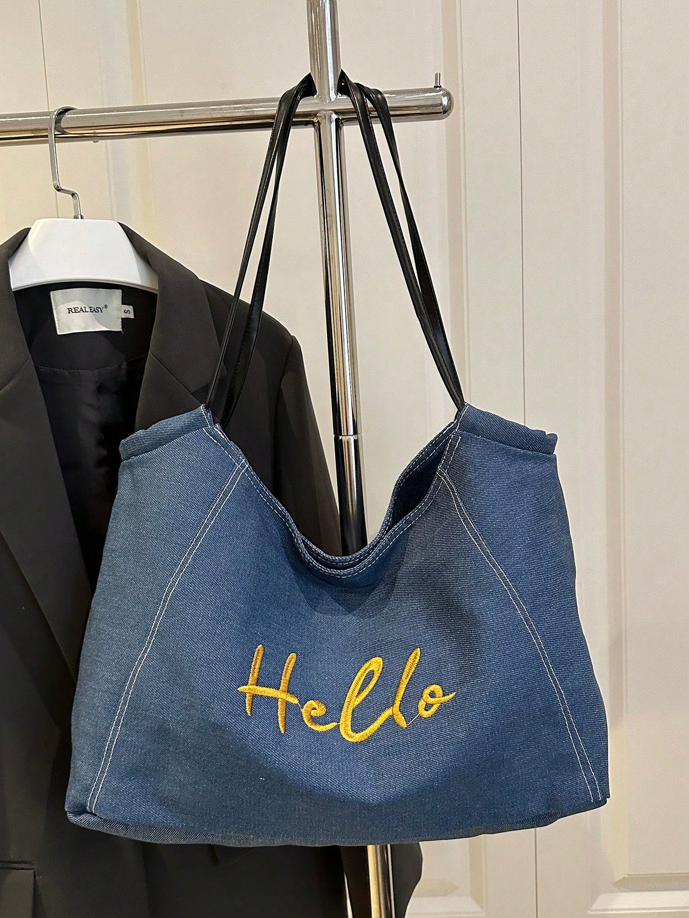 Brighten your summer days with this playful blue nylon tote bag! Lightweight and durable, it features a secure metal snap closure and charming embroidery that adds a fun, stylish touch. Perfect for carrying your essentials on casual outings, this tote combines practicality with a splash of personality.