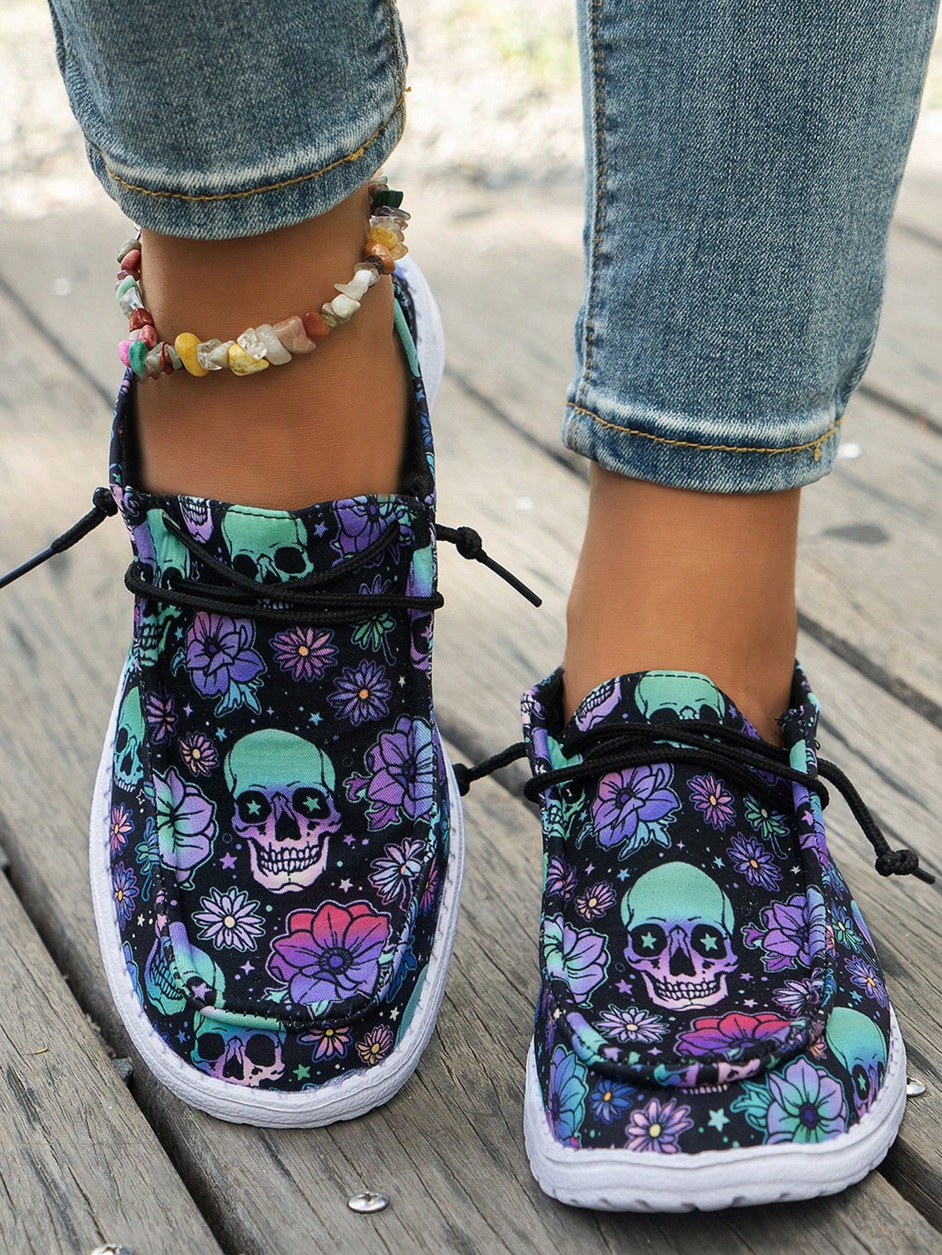 Step into spooky style with these Halloween-themed women's canvas sneakers. Featuring a striking black and blue floral pattern accented by a bold skull design, they bring festive flair to your footwear. Lightweight and crafted with a non-slip sole, these sneakers keep you comfortable and steady whether you're trick-or-treating or just showing off your seasonal spirit. Perfect for adding a playful edge to your fall wardrobe!