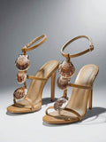 Front three-quarter pair view of khaki scallop-shell T-strap square-toe stiletto sandals with ankle buckle for beach party styling
