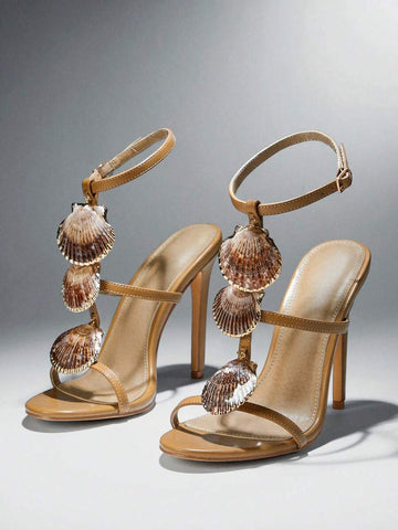 Front three-quarter pair view of khaki scallop-shell T-strap square-toe stiletto sandals with ankle buckle for beach party styling