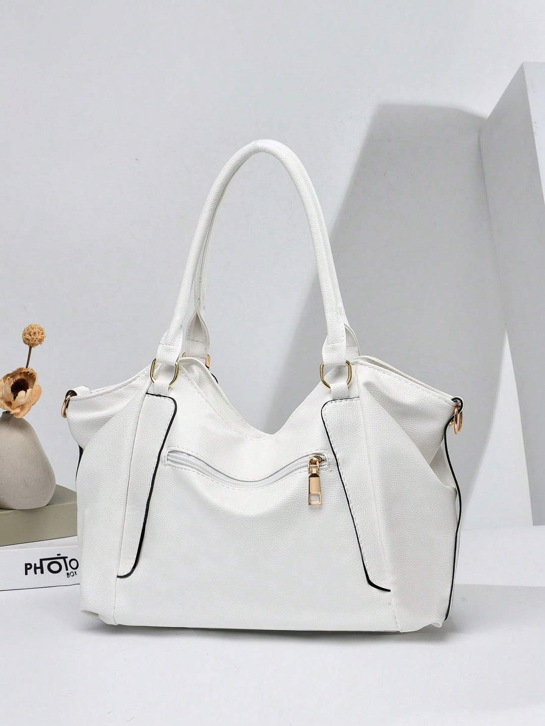 Carry your essentials with a dash of flair! This medium tote features a chic litchi-embossed texture and eye-catching metal accents, making it as stylish as it is practical. Perfect for busy moms on the go or as a thoughtful Mother’s Day gift, it blends fashion with function effortlessly. Whether running errands or heading out on a fun adventure, this tote keeps you organized and looking fabulous every step of the way.