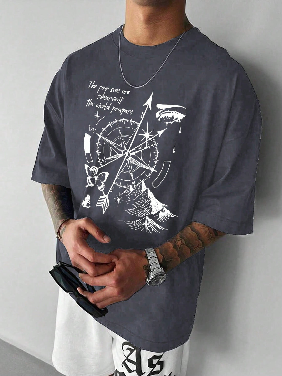 Unleash your inner explorer with this compass-print tee that's all about keeping it cool and casual! The loose fit gives you room to move, breathe, and maybe even dance a little. Perfect for guys who want to look put-together without trying too hard – just throw it on and let your style compass point to awesome. Adventure awaits, no map required!