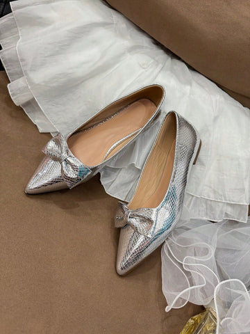 Elevate your shoe game with these stylish minimalist silver pointed toe flats. Perfect for all seasons, these flats offer ultimate comfort while still maintaining street style. Step out in confidence and turn heads with every step.