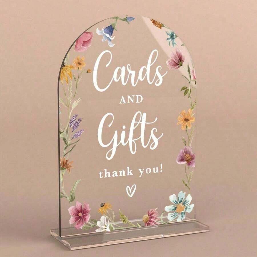 Elevate your wedding day with this stunning acrylic sign featuring modern calligraphy and a delicate wild flower arch. The sleek design combines contemporary elegance with natural botanical beauty, creating a sophisticated focal point for your ceremony or reception. Perfect for photo backdrops, welcome displays, or sweetheart table settings. The clear acrylic allows light to shine through, adding dimension and visual interest to your event decor. A timeless piece that captures the essence of modern romance.