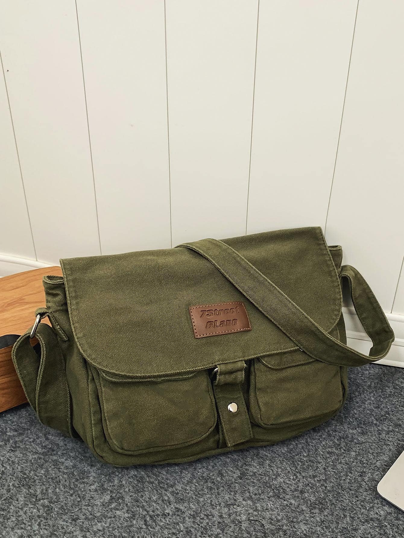 Crafted from durable canvas, this messenger bag combines vintage Japanese aesthetics with practical functionality. The spacious interior accommodates daily essentials, while strategically placed pockets keep smaller items organized and accessible. Its structured silhouette and adjustable shoulder strap provide comfortable, hands-free carrying for work, travel, or casual outings. The retro Harajuku-inspired design adds character to any wardrobe, making it equally suited for fashion-forward styling or underst