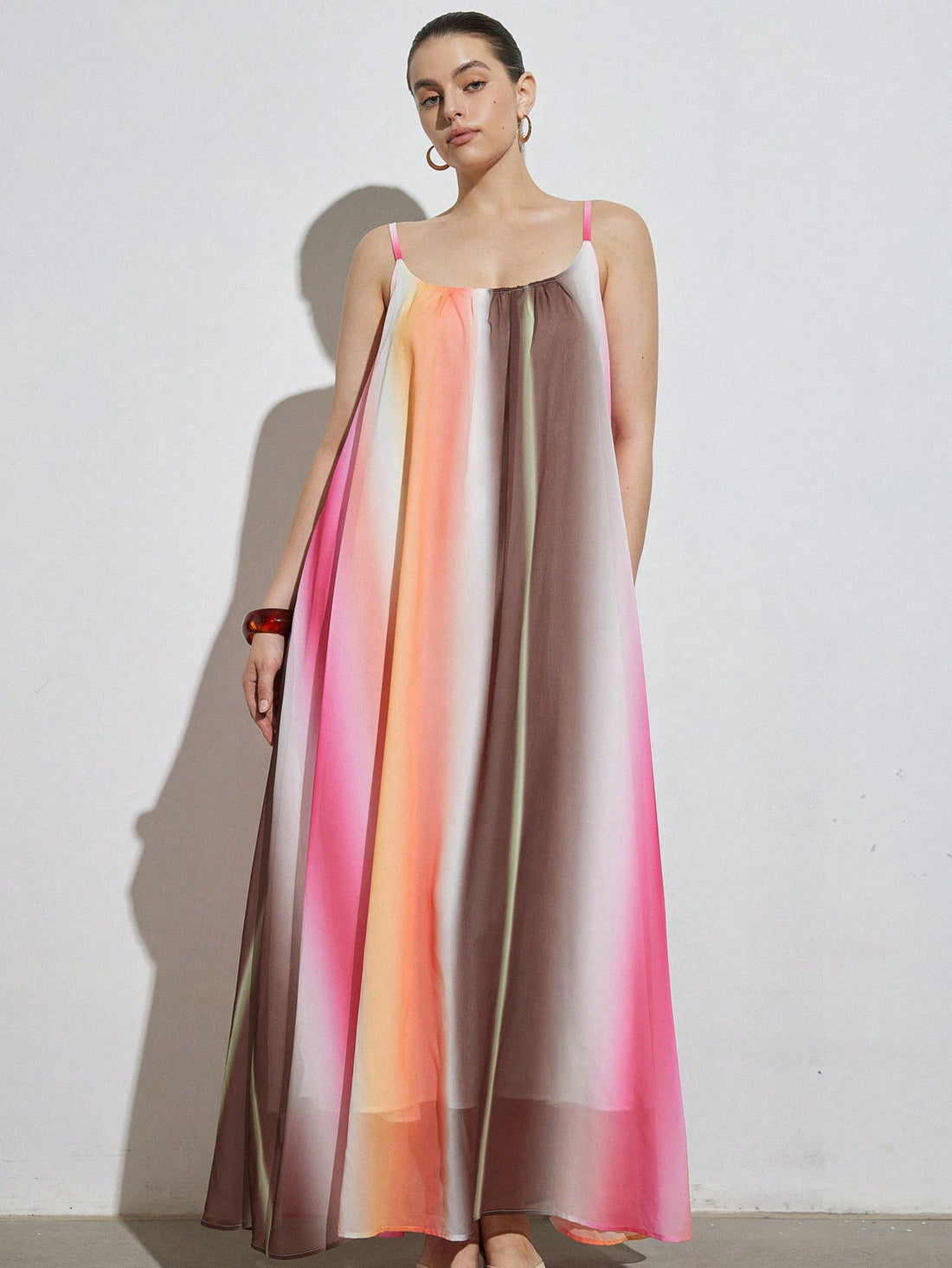 Celebrate vibrant style and comfort with this plus-size maxi dress featuring a playful rainbow gradient. Its flattering V-neck and sleeveless design keep you cool and confident, perfect for casual outings or beach days. Flowing fabric moves with you, making every step feel like a breeze of fun and color.