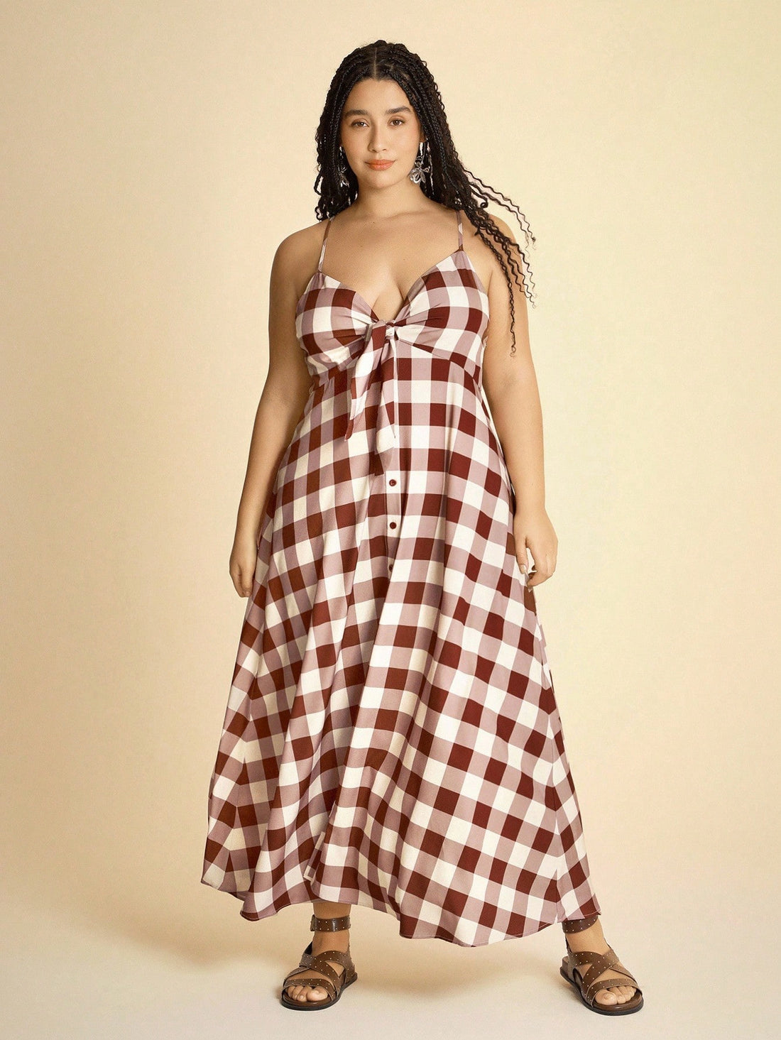 Step into vacation mode with this playful plus size checkered dress! Featuring a flattering V-neck and sleeveless design, it’s perfect for warm days. The tie knot adds a fun, flirty touch while highlighting your waist. Lightweight and breezy, this dress combines comfort with style effortlessly, making it your go-to for beach walks or casual outings. Embrace your curves and vacation vibes all in one chic look!