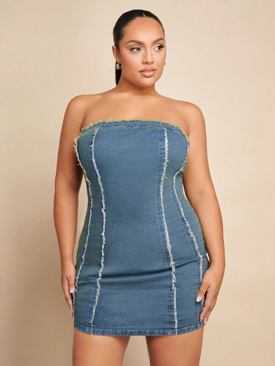 Turn heads with this playful plus size strapless denim dress, featuring trendy frayed edges for a carefree vibe. Perfect for effortless chic, it hugs your curves while keeping comfort front and center. Whether you're out for brunch or a casual night, this dress adds a fun, flirty touch to your wardrobe.