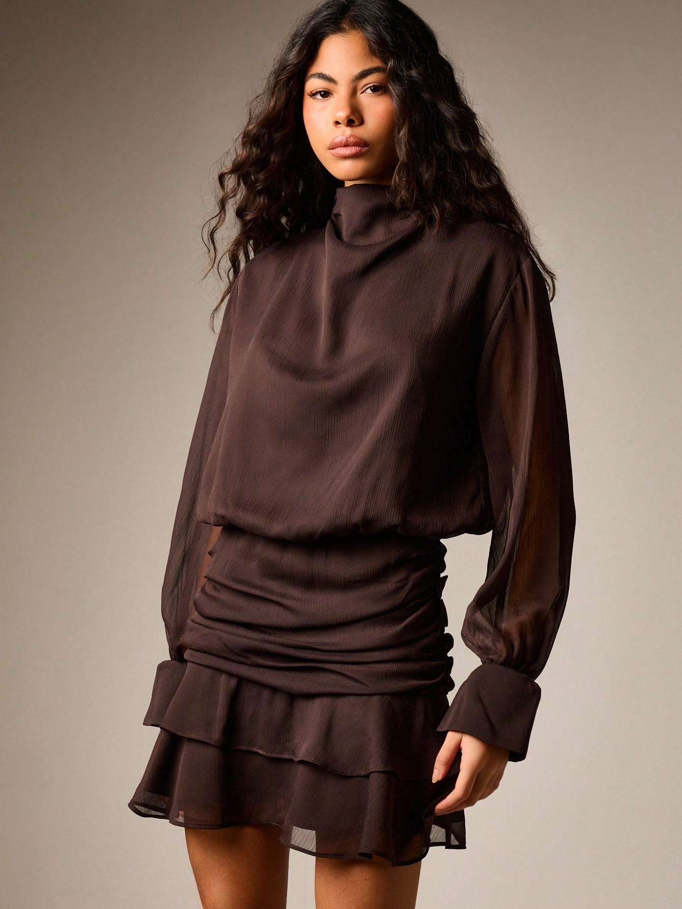 Turn heads at your next cocktail soirée in this chic ruched turtleneck mini dress. The fitted turtleneck hugs your silhouette while the playful ruffle skirt adds movement and flair—perfect for dancing the night away. Crafted for fall and winter gatherings, this dress transitions effortlessly from dinner to drinks. The ruching detail flatters your figure while the mini length shows off your style. Whether you're hitting a holiday party or weekend celebration, this is the dress that makes you feel confident a