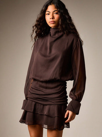 Turn heads at your next cocktail soirée in this chic ruched turtleneck mini dress. The fitted turtleneck hugs your silhouette while the playful ruffle skirt adds movement and flair—perfect for dancing the night away. Crafted for fall and winter gatherings, this dress transitions effortlessly from dinner to drinks. The ruching detail flatters your figure while the mini length shows off your style. Whether you're hitting a holiday party or weekend celebration, this is the dress that makes you feel confident a