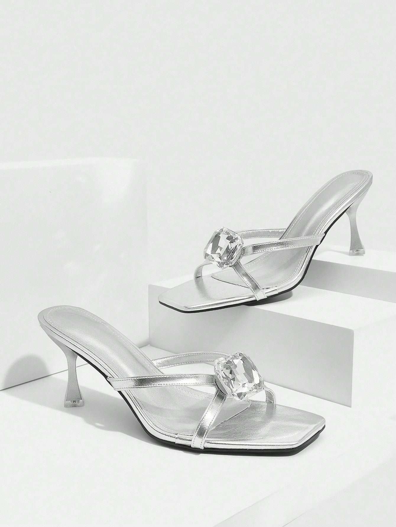 Step into sophistication with these stunning silver criss-cross high heel sandals, where elegance meets eye-catching sparkle. The intricate glass embellishments catch the light beautifully, adding a touch of glamour to any outfit. Designed with a flattering criss-cross strap detail, these heels offer both style and comfort for nights out, special occasions, or whenever you want to feel fabulous. Perfect for elevating your wardrobe with a shoe that's equal parts chic and show-stopping.