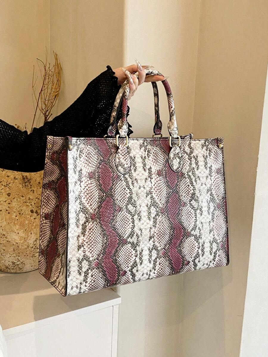 Slither into style with our eye-catching snake print oversized tote! This versatile companion handles everything from weekend getaways to grocery runs with effortless flair. The spacious interior keeps your essentials organized, while the bold reptilian pattern adds instant personality to any outfit. Durable construction means it's ready for year-round adventures, whether you're jet-setting or just hitting the shops. Perfect for anyone who refuses to blend in!